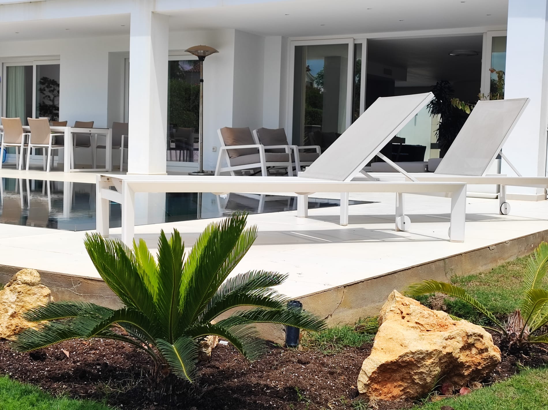 Pool deck with loungers, outdoor lounge and dining under the porch