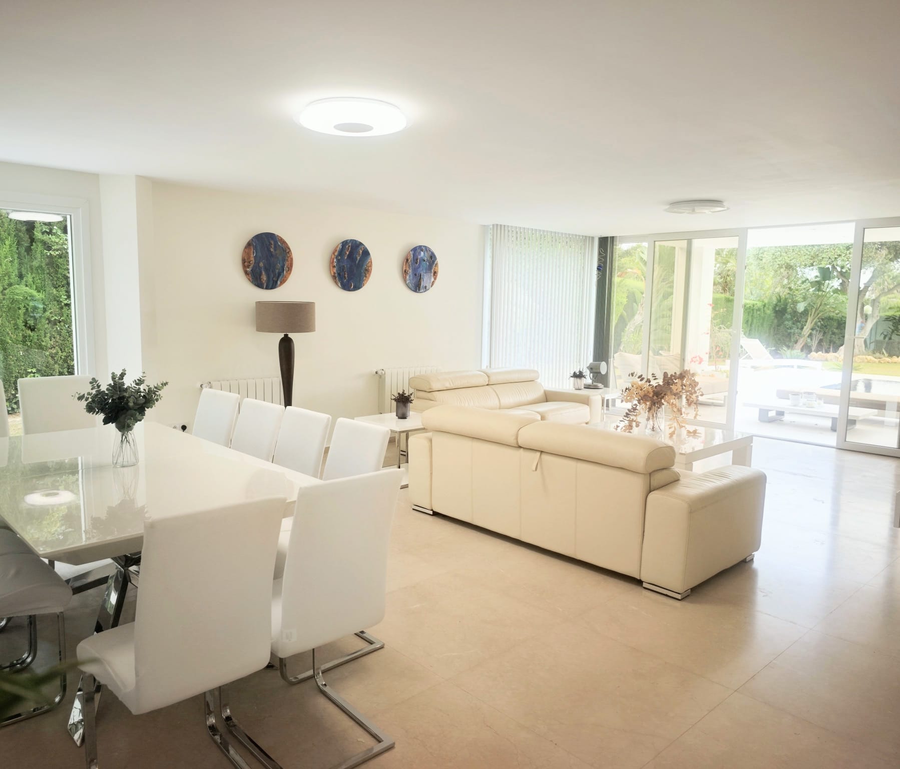 Open-plan lounge and dining area opening onto the pool terrace
