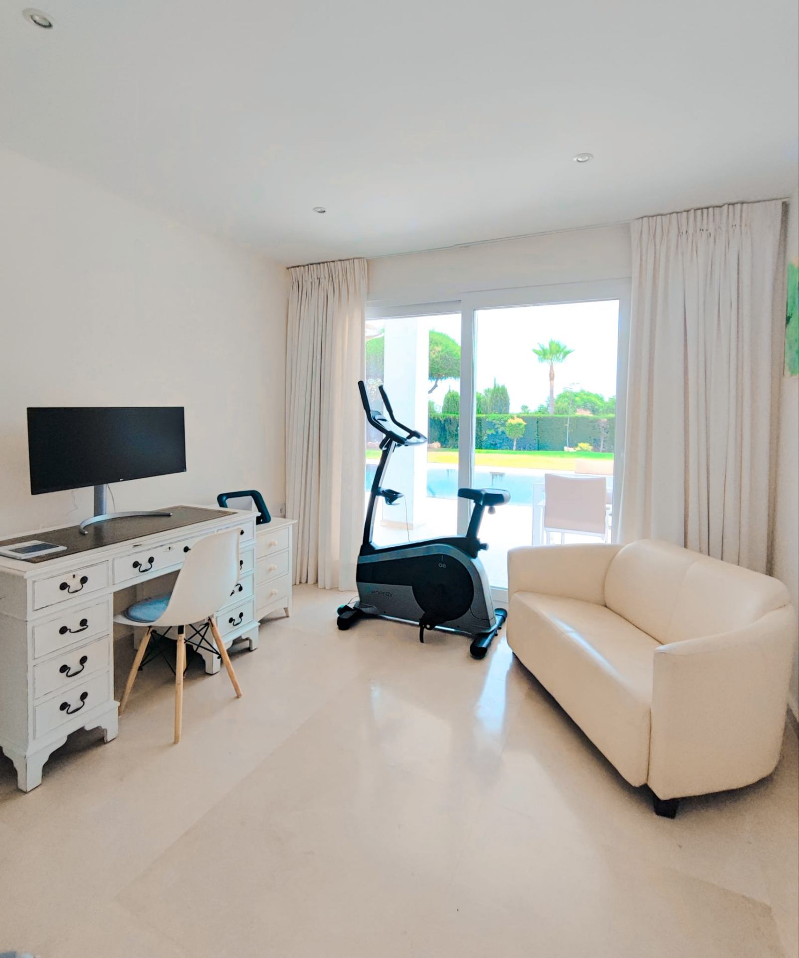 Study and fitness corner overlooking the pool terrace